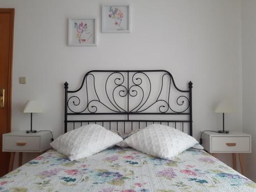 a bedroom with a bed with two pillows on it at Amorosa Beach Sun And Sea in Viana do Castelo
