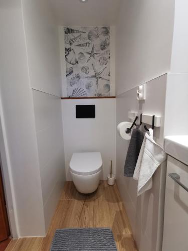 a small bathroom with a toilet and a sink at Wild Wine House in Gdynia