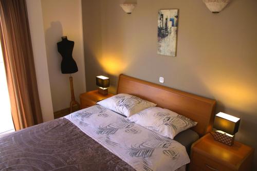 a bedroom with a bed with two pillows on it at Apartments Kimm's Hideaway in Poreč