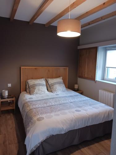 a bedroom with a large bed in a room at Gîte de Rosvern in Commana