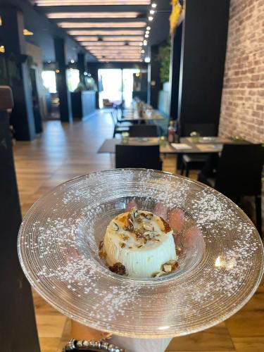 a dessert on a glass plate on a table at Hotel Spigamonti in Negrar