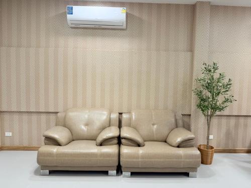 a couch sitting in a living room with a ceiling at Homey At The Dam, Private House in Ban Ta Khun