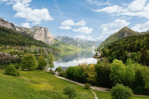 a view of a lake in a valley with mountains at MONDI Hotel am Grundlsee in Grundlsee