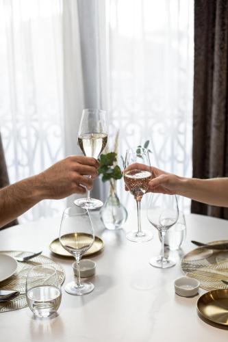 a group of people holding glasses of wine on a table at Hospes Palau de La Mar, Valencia, a Member of Design Hotels in Valencia