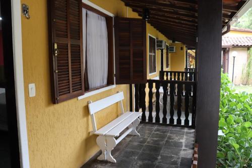 a bench sitting on the side of a building at Hotel Casa Encantada in Penedo