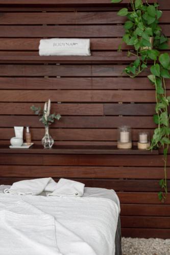 a bedroom with a wooden accent wall with a bed at Hospes Palau de La Mar, Valencia, a Member of Design Hotels in Valencia