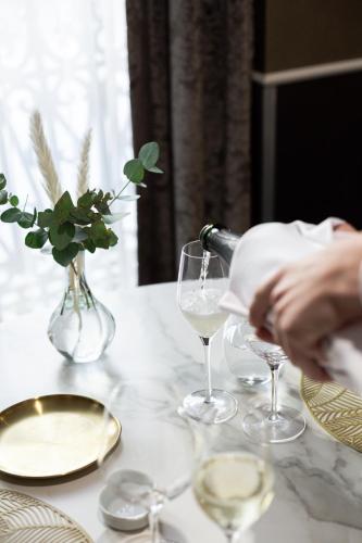 a table with a bottle of wine and glasses on it at Hospes Palau de La Mar, Valencia, a Member of Design Hotels in Valencia