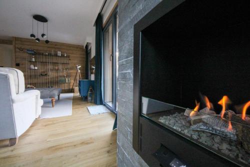 a fireplace in a living room with a fire place at Apartment Aiguille Rose in Les Houches