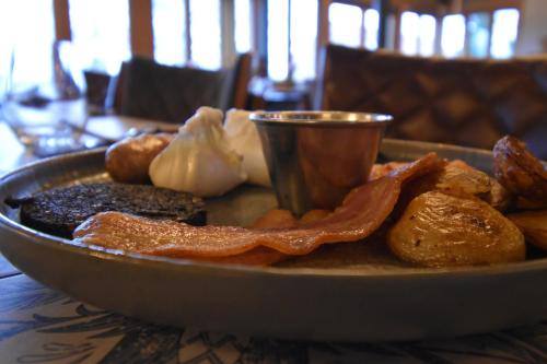a plate of food on a table with a plate of food at Guinness Arms in Icklingham