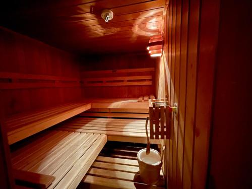 a sauna with a tub and a toilet in it at Hotel Garni Zerzer in Serfaus