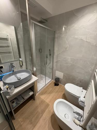 a bathroom with a sink and a toilet and a shower at LaBienbi' in Cosenza