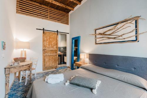 a bedroom with a large bed and a desk at Casa Mauro e Roberta Zingaro in Castellammare del Golfo