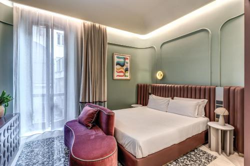 a bedroom with a bed and a chair at Dimora Coppelle in Rome