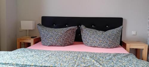 a bedroom with a bed with two pillows on it at Ferienwohnung mit 3 Schlafzimmern im Vogtland in Heinsdorfergrund