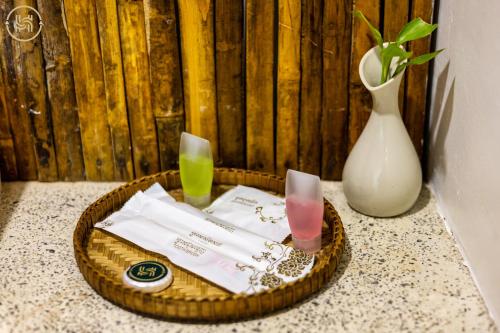 a basket with two drinks and a vase at Green BOUTiQUE in Siem Reap