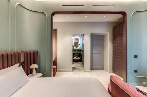 a bedroom with a bed and a mirror at Dimora Coppelle in Rome