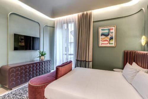 a bedroom with a bed and a chair and a window at Dimora Coppelle in Rome