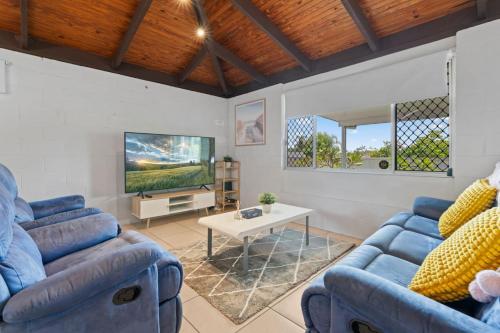 a living room with two blue couches and a tv at Small Groups and Families Stylish 3Beds near mall in Marsden