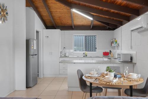 a kitchen with a table and chairs in a kitchen at Small Groups and Families Stylish 3Beds near mall in Marsden