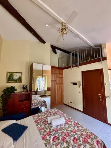 a bedroom with two beds and a ceiling fan at Wonderful Como in Como