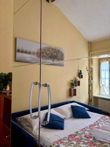 a bedroom with a bed with blue pillows at Wonderful Como in Como