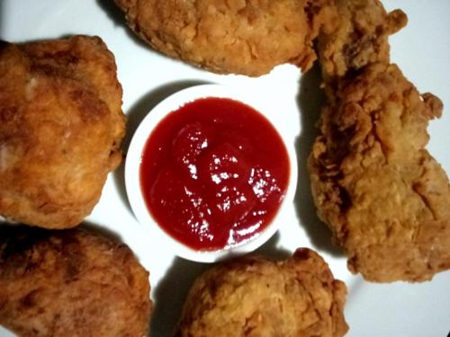 a plate of food with a bowl of dipping sauce at The blue sky in Ahangama
