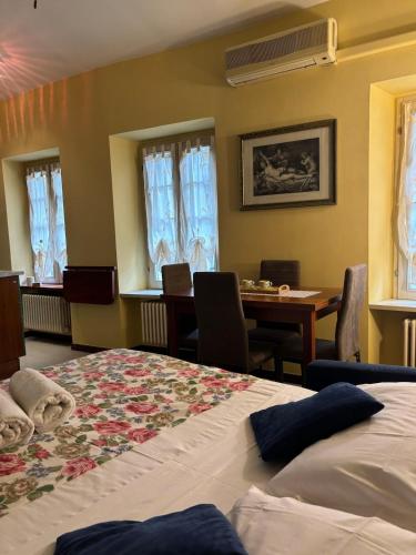 a bedroom with two beds and a dining room with a table at Wonderful Como in Como