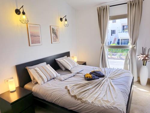 ein Schlafzimmer mit einem Bett und einem Fenster in der Unterkunft Pearl of Amarilla Golf - Luxury 3 Bedroom Villa with heated pool & ocean view in San Miguel de Abona