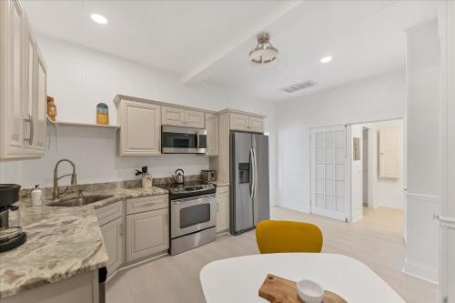 a kitchen with white cabinets and stainless steel appliances at TAY307-B in Punta Gorda