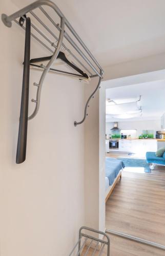 a bedroom with a bed and a metal staircase in a room at Ruhig Top mod Studio Appartement,privater Eingang in Oberhaching