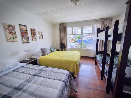 a hotel room with two beds and a window at Casa Jardin del Mango in San José