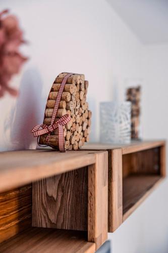 a basket of fire wood sitting on a wooden table at Penthouse in den Bergen in Imst