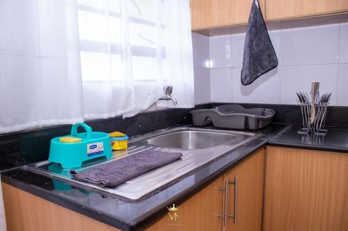 a kitchen counter with a sink and a window at The Monarch Suites- Peaceful Luxe 2BR with view in Nakuru