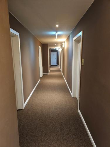 an empty hallway in a building with brown walls at Parklane Boutique Hotel - Newly Renovated in Vienna
