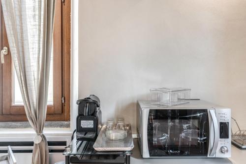 a microwave sitting on a counter next to a toaster oven at Casa Navona Apartments in Rome