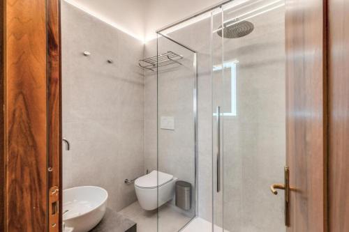 a bathroom with a toilet and a glass shower at Casa Navona Apartments in Rome