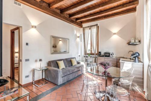 a living room with a couch and a glass table at Casa Navona Apartments in Rome