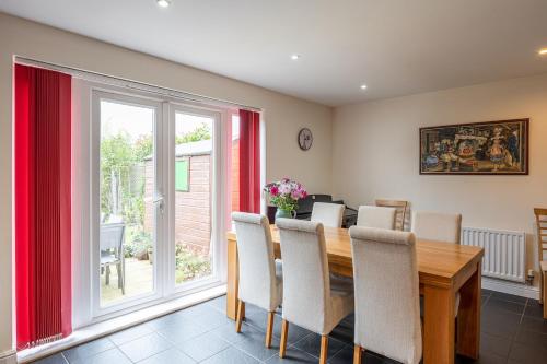 a dining room with a wooden table and chairs at Dalesway View in Addingham