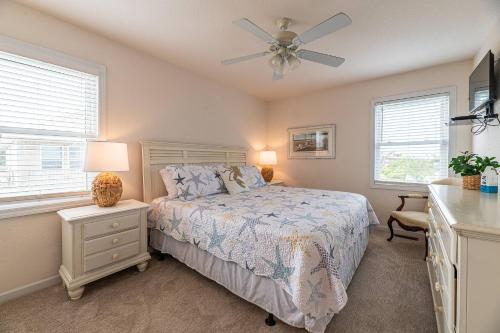 a bedroom with a bed and a ceiling fan at Boss's Playhouse in Kill Devil Hills
