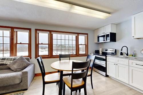 a kitchen and living room with a table and chairs at Suncook Studio in Pittsfield