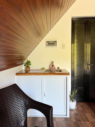 a kitchen with a sink and a wooden ceiling at Garden of Faith Lodge - 20 minutes drive from Tagaytay in Calaca