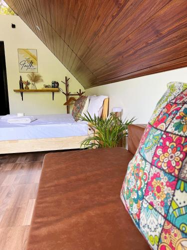 a bedroom with a large bed and a couch at Garden of Faith Lodge - 20 minutes drive from Tagaytay in Calaca