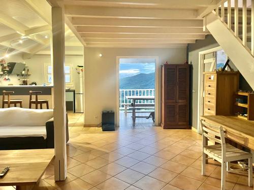 a room with a bed and a kitchen with a view at Villa martinique in Sainte-Luce
