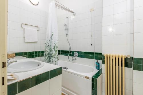 a bathroom with a tub and a sink at BeRGAMO ALTA - Piazza Mercato del Fieno HOUSE in Bergamo