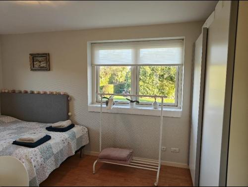 a bedroom with a bed and a window at Charming ROOM in a Cozy Home in Stege in Stege