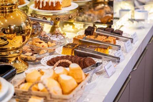 a buffet filled with lots of different types of desserts at Arca's Executive Hotel in Toledo