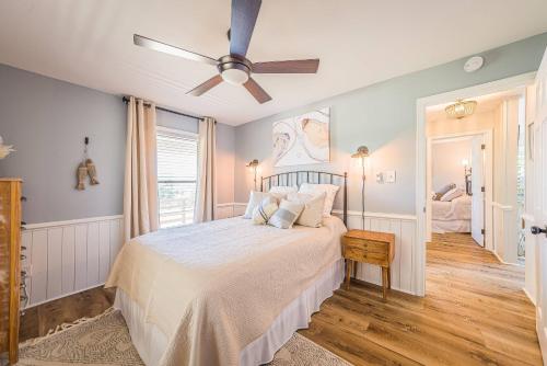 a bedroom with a bed and a ceiling fan at Beach Blessing in Southern Shores