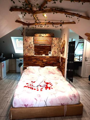 a bedroom with a large bed with red hearts on it at La Plumeria in Baincthun