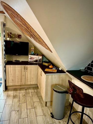 a room with a staircase with a counter and a trash can at La Plumeria in Baincthun