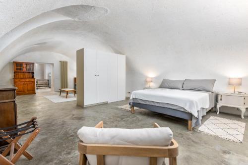 a bedroom with a bed and a couch in a room at BeRGAMO ALTA - Piazza Mercato del Fieno HOUSE in Bergamo